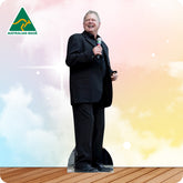 Man in a suit holding a microphone with 'Australian Made' logo on a colorful background